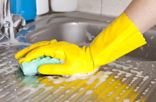 Technician using upholstery cleaning equipment on a chair